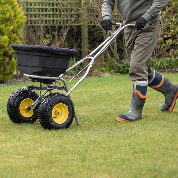 man operates a garden tiller