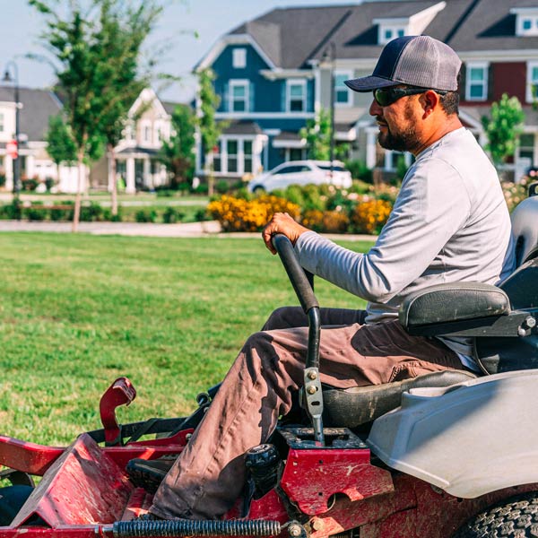 man mows the grass