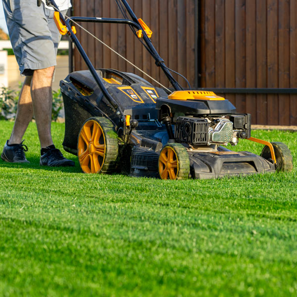 man mows the grass