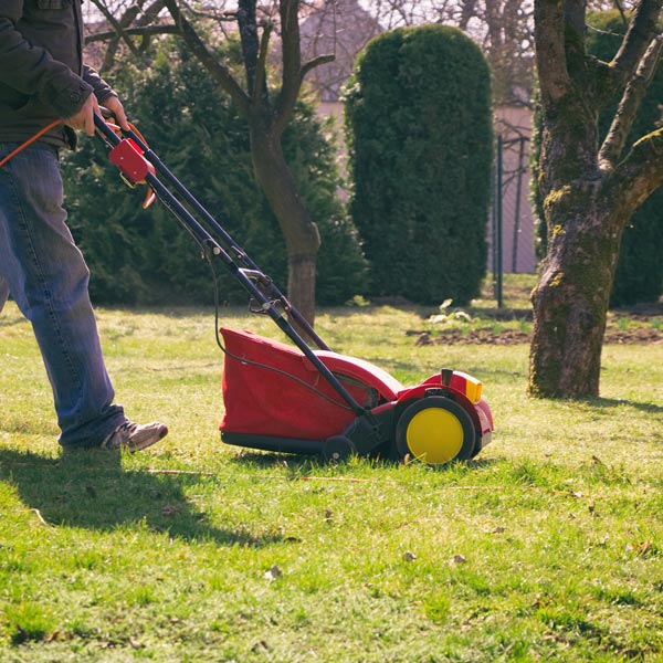 man mows the grass